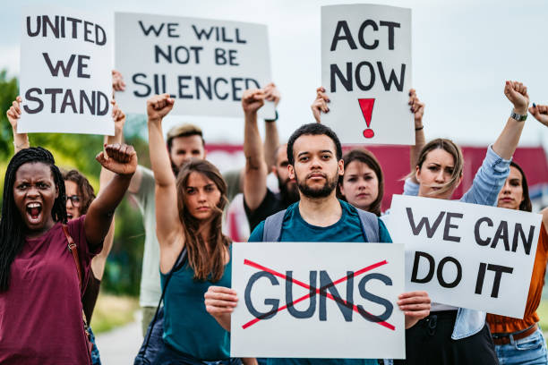 Gun right activists protest gun control legislation with placards and posters. 